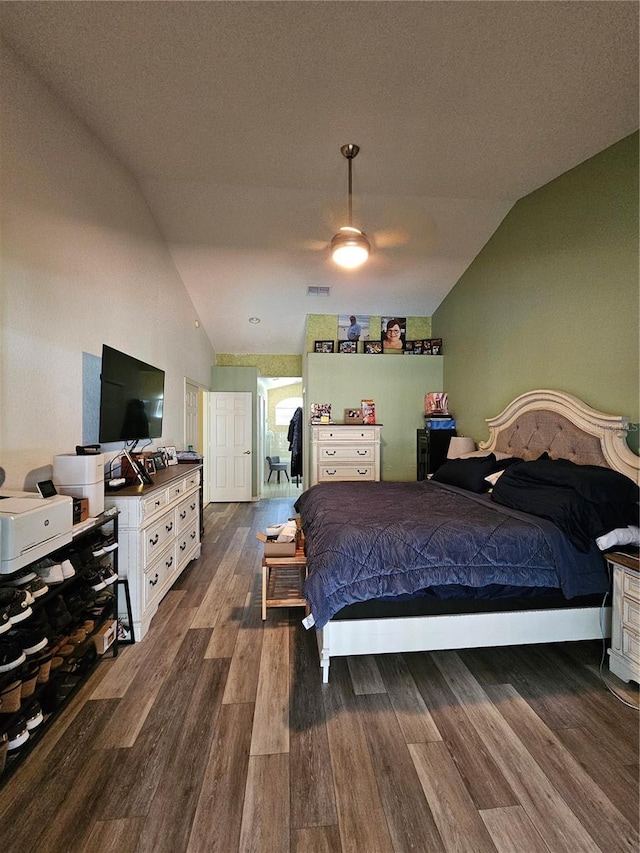 bedroom with ceiling fan, dark hardwood / wood-style flooring, and vaulted ceiling