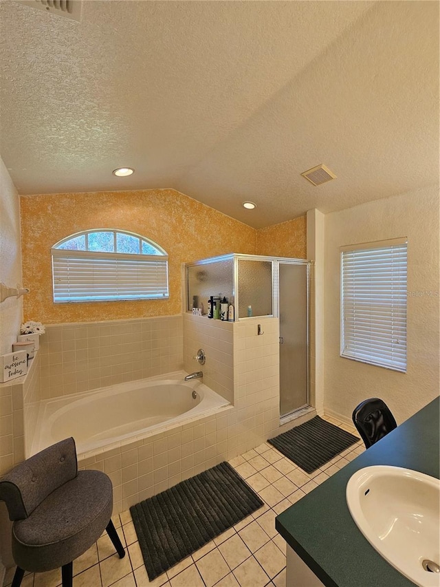 1072 Old Cutler Rd, Lake Wales, FL 33898 - bathroom featuring a garden tub, a stall shower, a textured ceiling, tile patterned flooring, and vaulted ceiling
