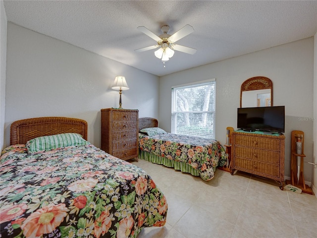 tiled bedroom featuring ceiling fan and a textured ceiling