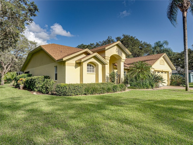 view of front of home with a front lawn and a garage