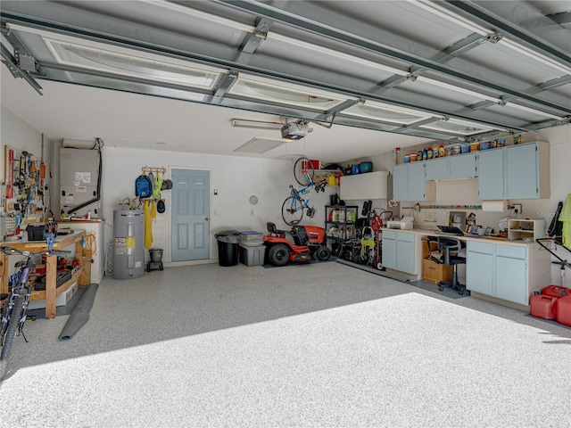 garage featuring a workshop area, electric water heater, and a garage door opener