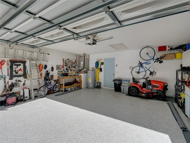 garage featuring water heater and a garage door opener