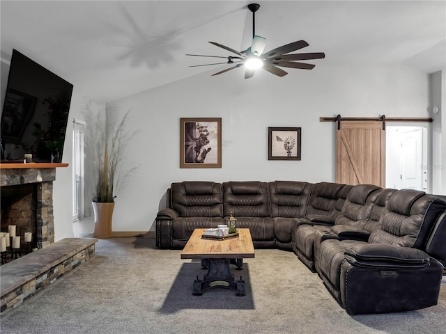 living room featuring a barn door, ceiling fan, carpet floors, and vaulted ceiling