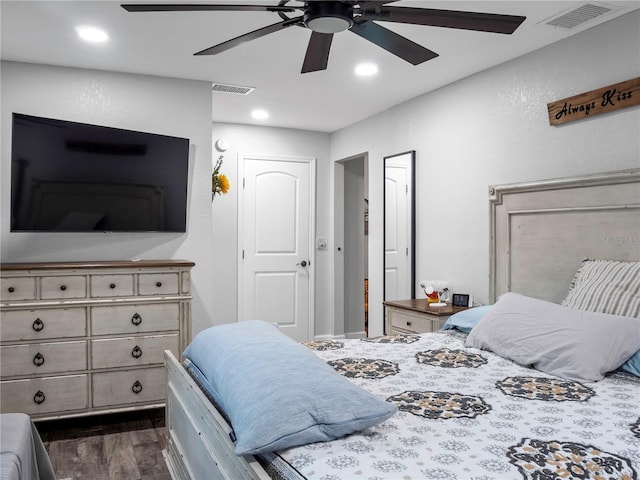 bedroom with dark hardwood / wood-style floors and ceiling fan