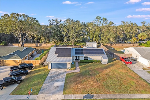 view of front of property with a garage and solar panels