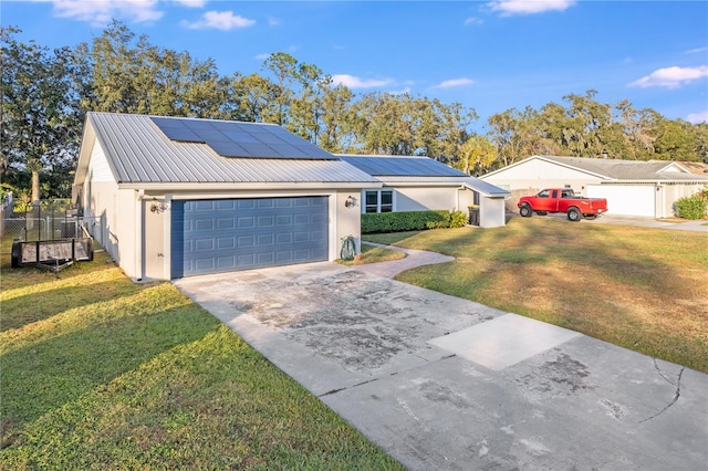 ranch-style home with solar panels, a garage, and a front lawn