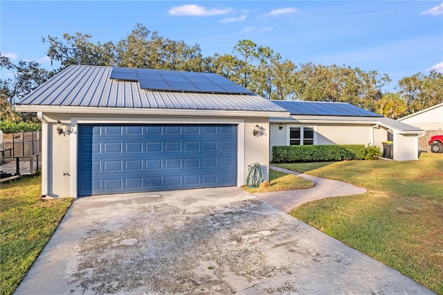 ranch-style home featuring solar panels, a garage, and a front lawn