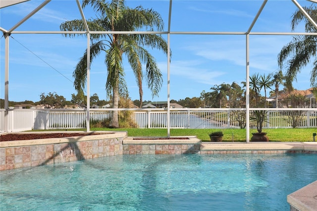 view of swimming pool featuring pool water feature and a lanai