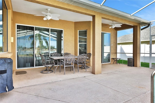 view of patio with ceiling fan and a lanai