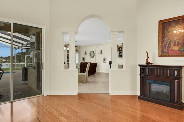 living room with hardwood / wood-style flooring and ornate columns