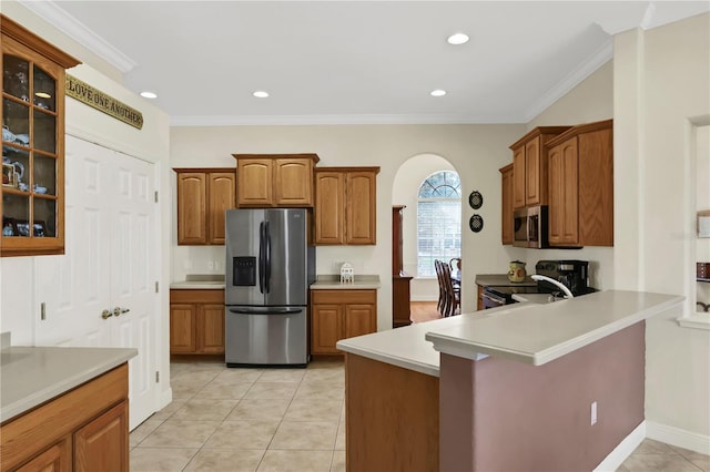 kitchen featuring kitchen peninsula, light tile patterned floors, crown molding, and appliances with stainless steel finishes