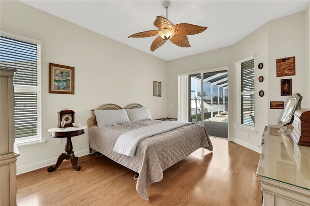 bedroom featuring access to outside, multiple windows, ceiling fan, and light hardwood / wood-style flooring