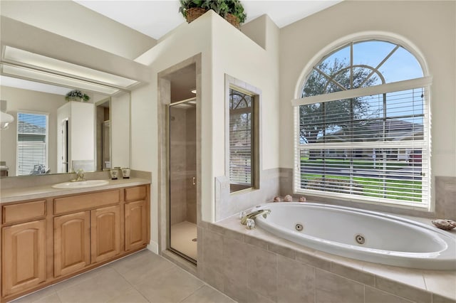 bathroom featuring tile patterned flooring, plenty of natural light, shower with separate bathtub, and vanity