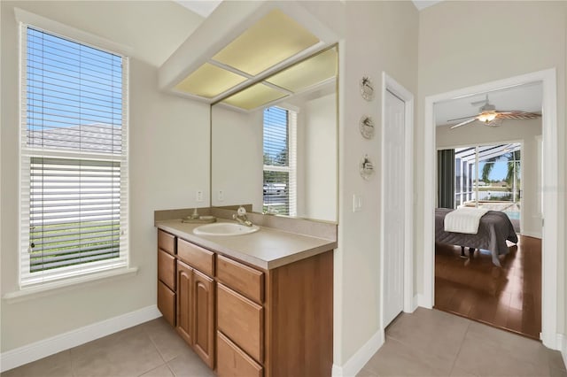 bathroom featuring tile patterned flooring, vanity, a healthy amount of sunlight, and ceiling fan