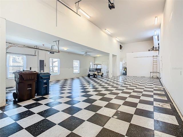 garage with electric panel, a garage door opener, and ceiling fan