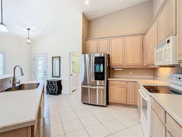 kitchen with pendant lighting, white appliances, sink, light tile patterned floors, and light brown cabinetry