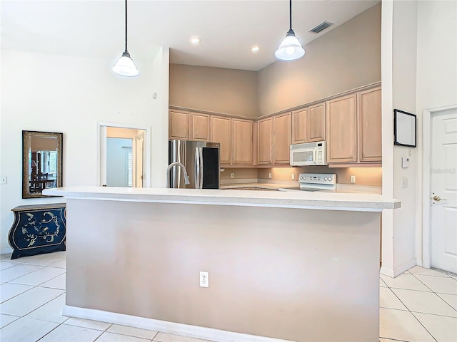 kitchen featuring light brown cabinetry, white appliances, and an island with sink