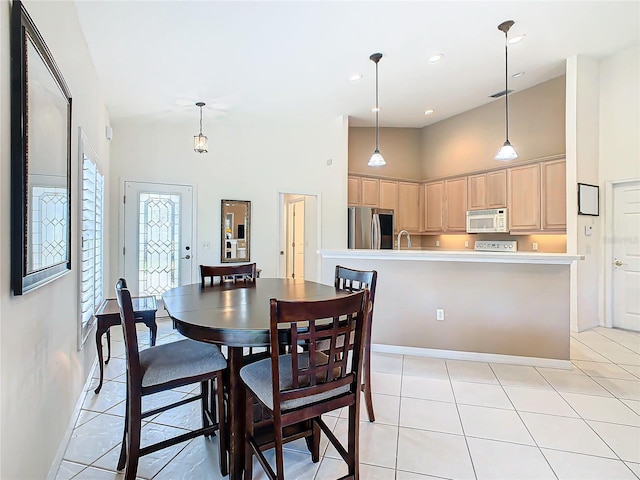 tiled dining room featuring a high ceiling