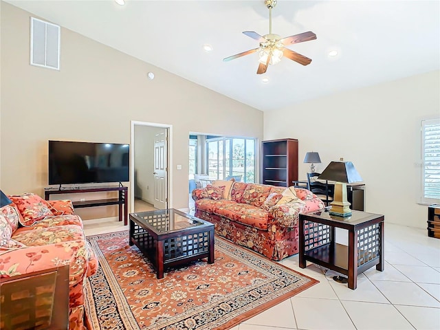 tiled living room featuring ceiling fan and high vaulted ceiling