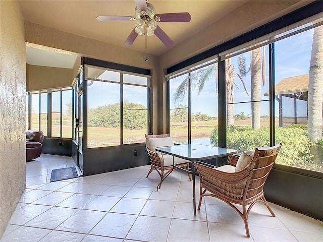 sunroom / solarium featuring ceiling fan