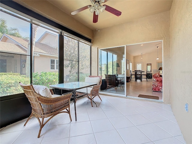 sunroom with plenty of natural light, ceiling fan, and vaulted ceiling