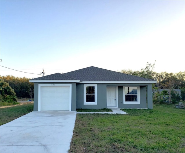 ranch-style house featuring a front lawn and a garage