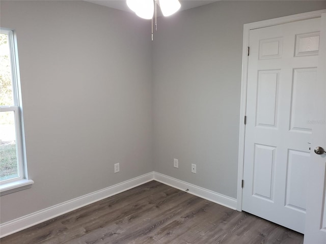 empty room featuring dark hardwood / wood-style flooring and a healthy amount of sunlight