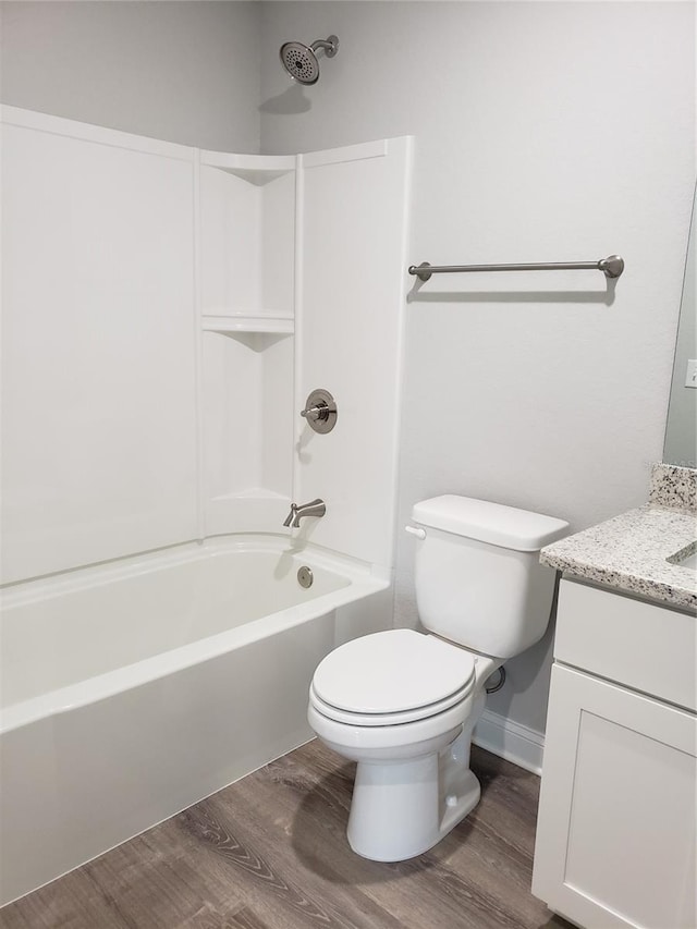 full bathroom featuring hardwood / wood-style floors, vanity, toilet, and shower / tub combination