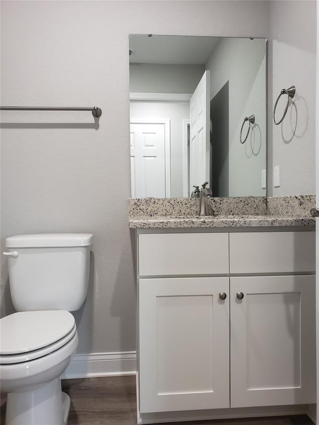 bathroom featuring hardwood / wood-style floors, vanity, and toilet