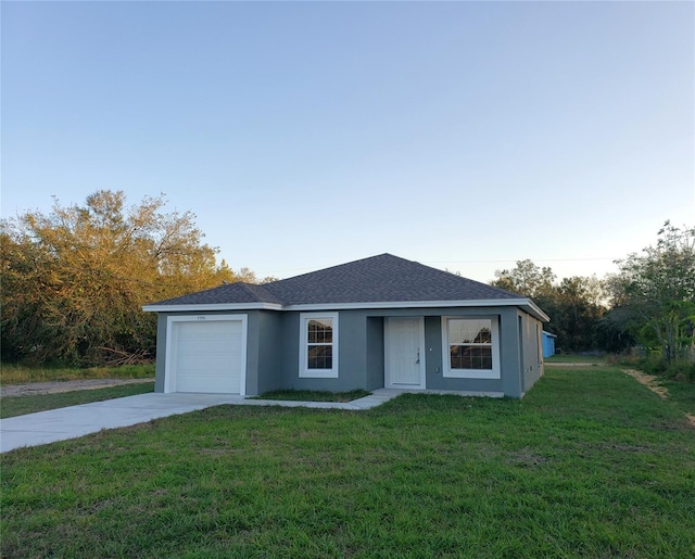 ranch-style home with a garage and a front lawn