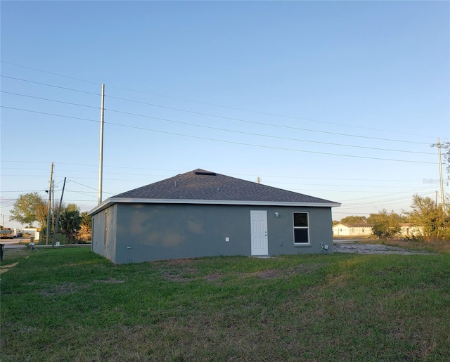 rear view of property with a lawn