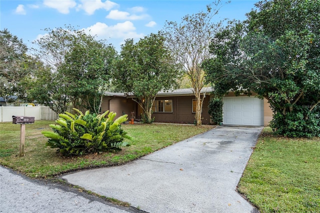 ranch-style house with a garage and a front yard