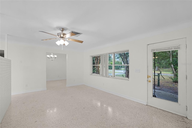 1891 18th St NW, Winter Haven, FL 33881 - empty room with speckled floor, ceiling fan, and a chandelier