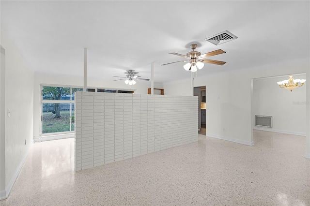 empty room featuring ceiling fan with notable chandelier