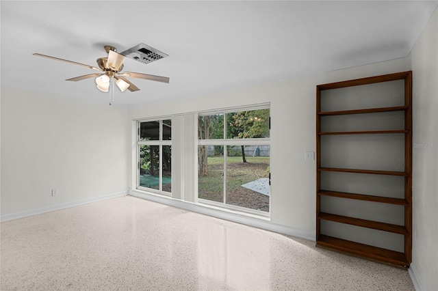 1891 18th St NW, Winter Haven, FL 33881 - empty room with speckle patterned floor and ceiling fan