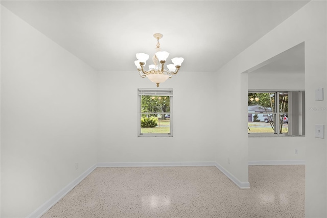 1891 18th St NW, Winter Haven, FL 33881 - empty room with a chandelier and speckled floor