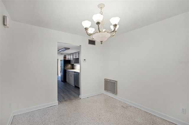 1891 18th St NW, Winter Haven, FL 33881 - spare room featuring a chandelier and dark speckled floor