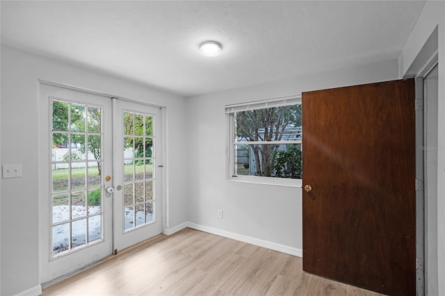 doorway to outside with plenty of natural light, light hardwood / wood-style flooring, and french doors