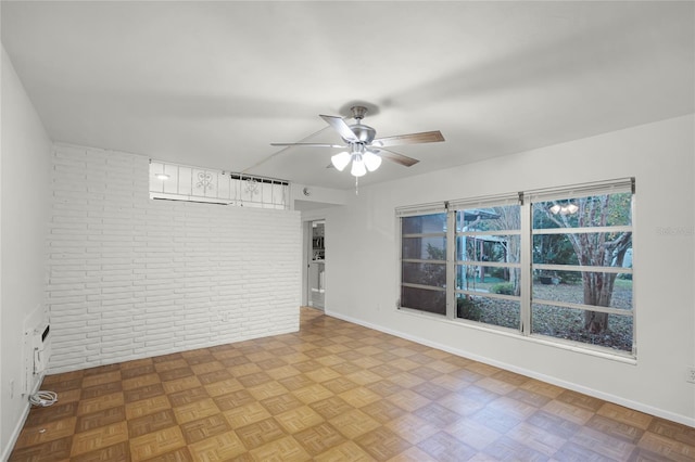 1891 18th St NW, Winter Haven, FL 33881 - spare room with brick wall and a ceiling fan