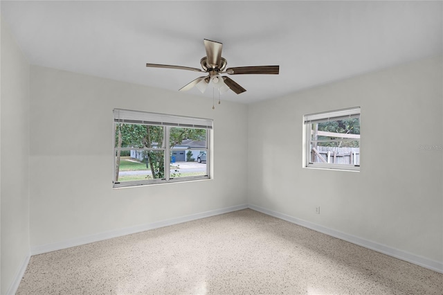 empty room featuring ceiling fan and a healthy amount of sunlight