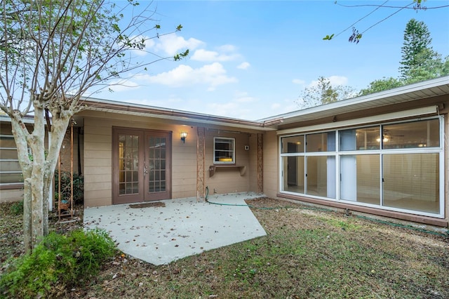 1891 18th St NW, Winter Haven, FL 33881 - rear view of house with french doors, a patio, and concrete block siding