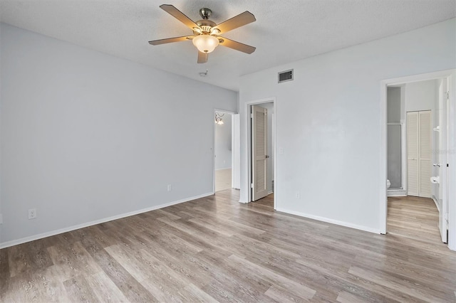 unfurnished bedroom with ceiling fan, light hardwood / wood-style flooring, and a textured ceiling