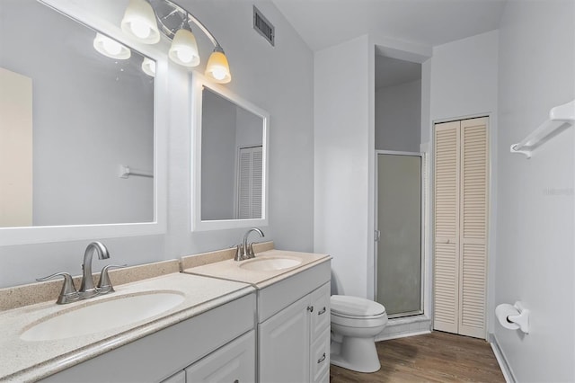 bathroom with hardwood / wood-style flooring, vanity, and toilet