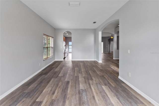 spare room with dark hardwood / wood-style flooring and ceiling fan