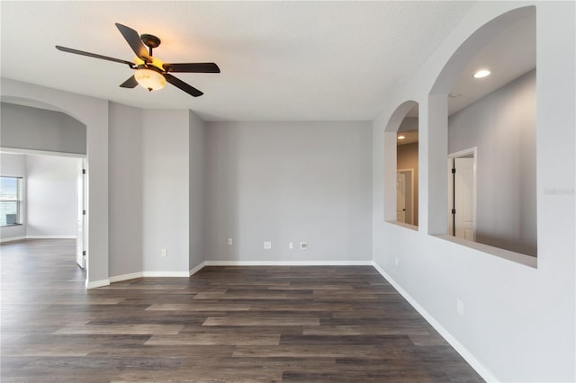 unfurnished room with ceiling fan, dark hardwood / wood-style flooring, and a textured ceiling