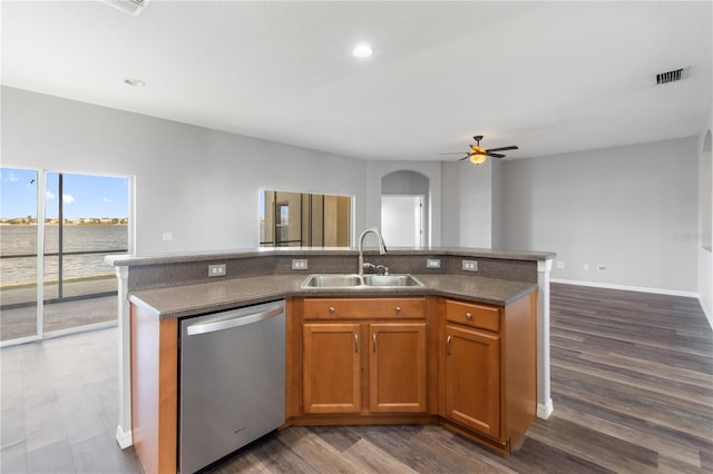 kitchen with dishwasher, dark hardwood / wood-style floors, a center island with sink, and sink