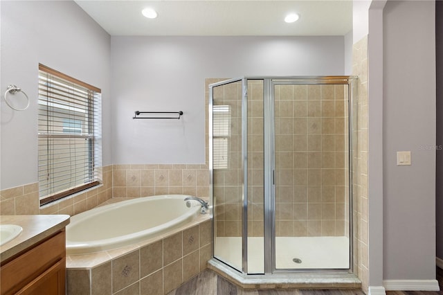 bathroom featuring vanity and shower with separate bathtub