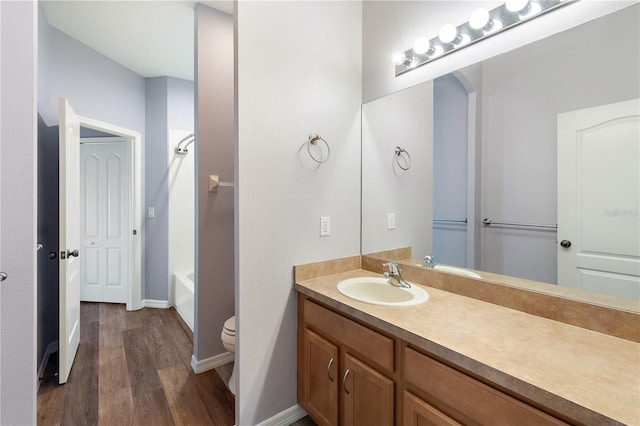 full bathroom featuring vanity, hardwood / wood-style flooring, toilet, and shower / bathtub combination