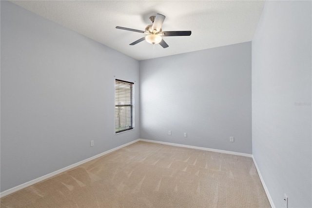 unfurnished room featuring ceiling fan and light colored carpet