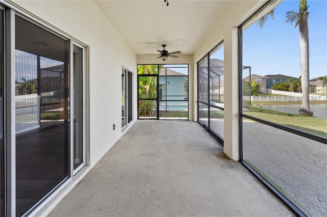 unfurnished sunroom featuring plenty of natural light and ceiling fan